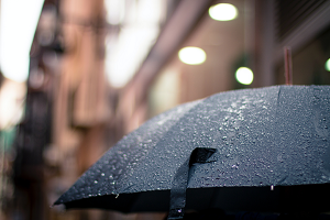 a black umbrella in the rain