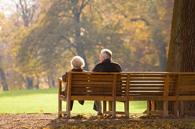 a person sitting on a wooden bench