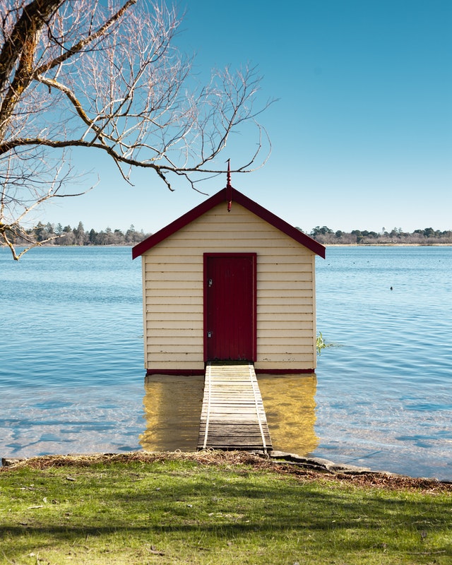 a small house in a body of water