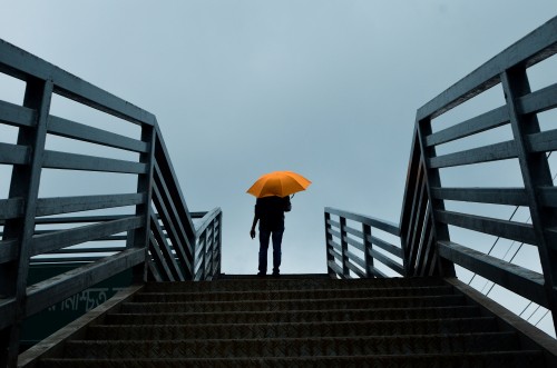 a person with an orange umbrella